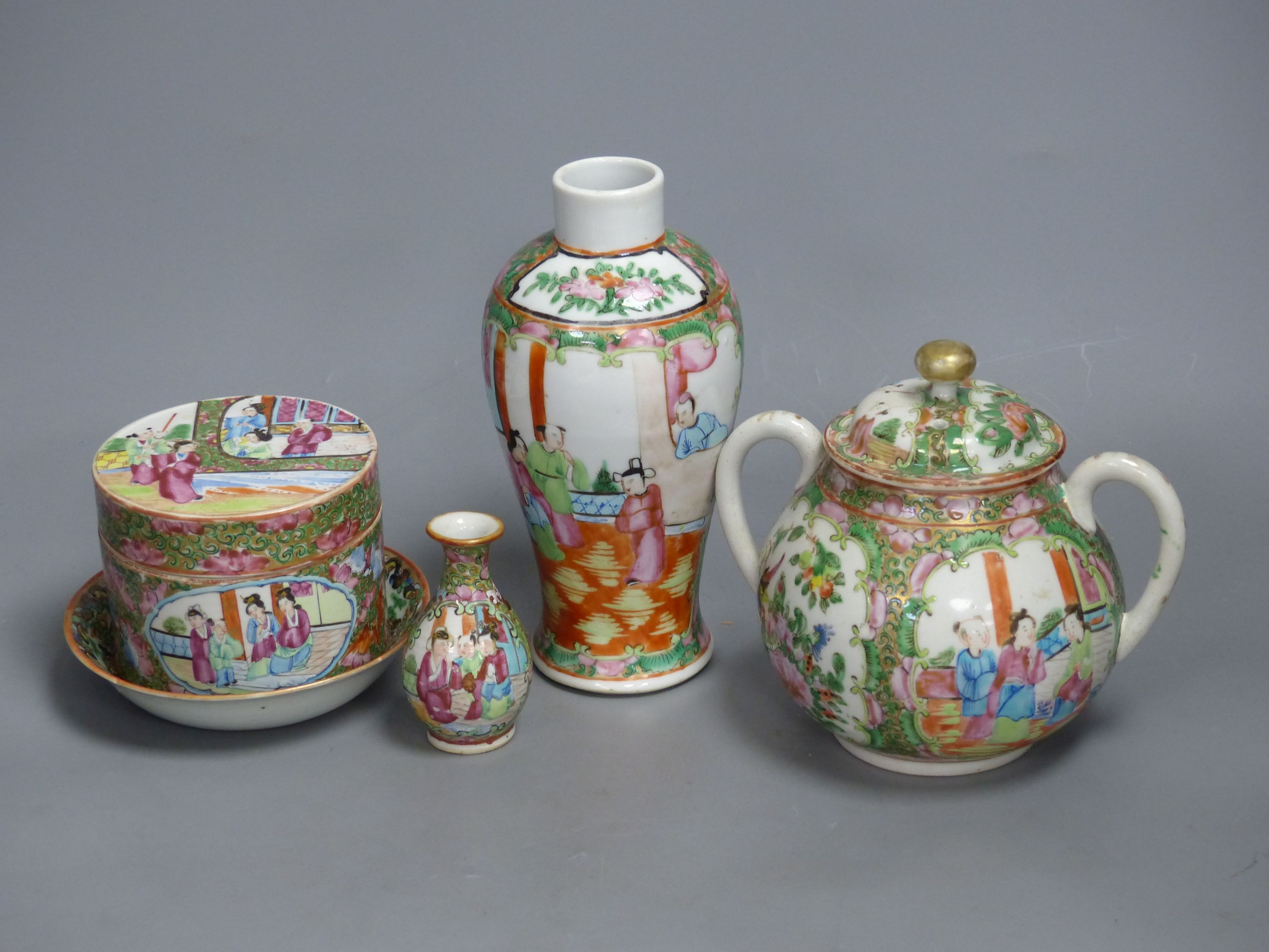 A Chinese famille rose box and cover, two vases, a sugar bowl and cover and a saucer, late 19th/early 20th century, tallest 19cm